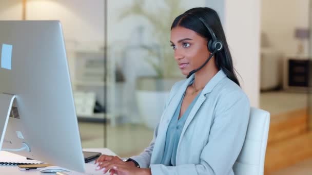 Female Call Center Agent Typing Email Computer While Wearing Headset — стоковое видео