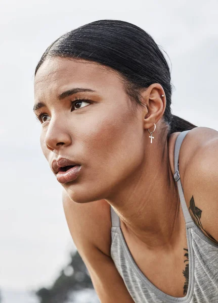 Yes its tough, but so are you. a young woman catching her breath while exercising outdoors