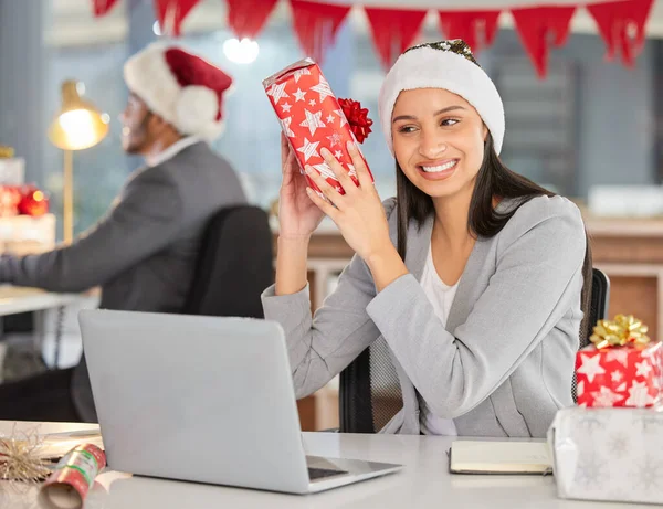 Is it a puppy. a young businesswoman receiving a gift in a modern office at Christmas