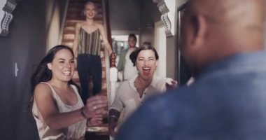 4k video footage of a group of young men and women excitedly welcoming their friend home.