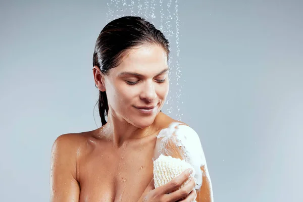 Lathering Young Woman Taking Shower Grey Background — Φωτογραφία Αρχείου