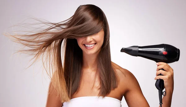 Lets Get Hair Dried Studio Shot Attractive Young Woman Blowdrying — стоковое фото