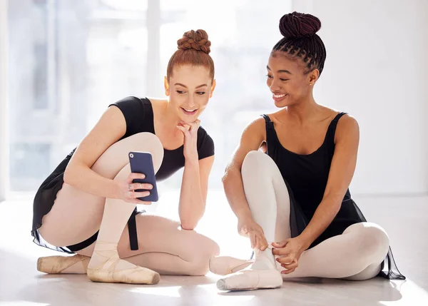 Can you believe they sent me that. two ballet dancers using a smartphone together