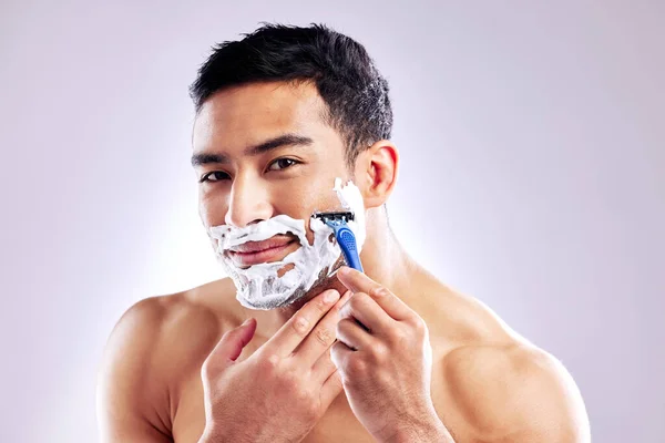 How often do you groom your facial hair. a handsome young man shaving his facial hair