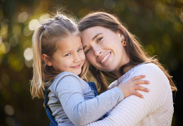 I will always hold her near and dear. Portrait of a mother and her little daughter bonding together outdoors