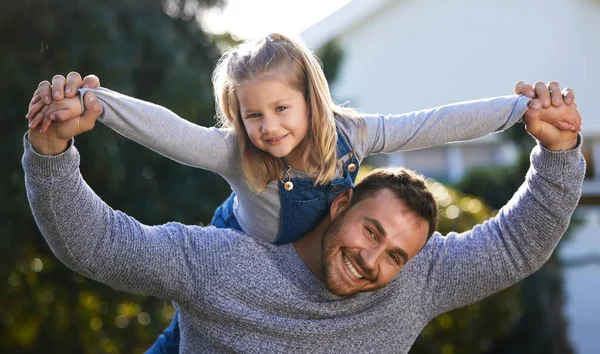 She keeps me active too. Portrait of a little girl having fun with her father outdoors