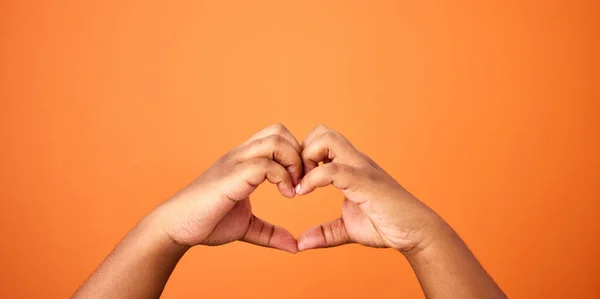 Love All Need Unrecognizable Person Showing Heart Gesture Orange Background — Stock fotografie