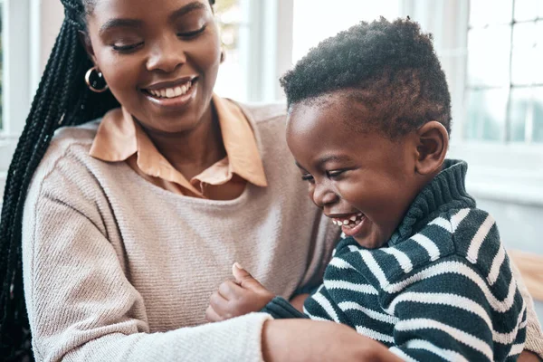 That tickles, mom. a little boy and his mother playing at home