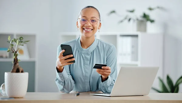 Businesswoman, finance advisor and executive shopping online with a phone and credit card in an office. Happy, smiling and cheerful trader banking with ecommerce internet payment while spending money.