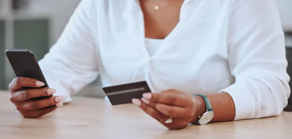 Payments, banking and shopping being done by a woman with a credit card and phone. Female entrepreneur, businesswoman or boss paying for a product on the internet, app or website online at work.
