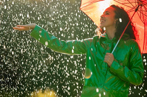 Enjoy every moment of life down to the last drop. a beautiful young woman having fun in the rain