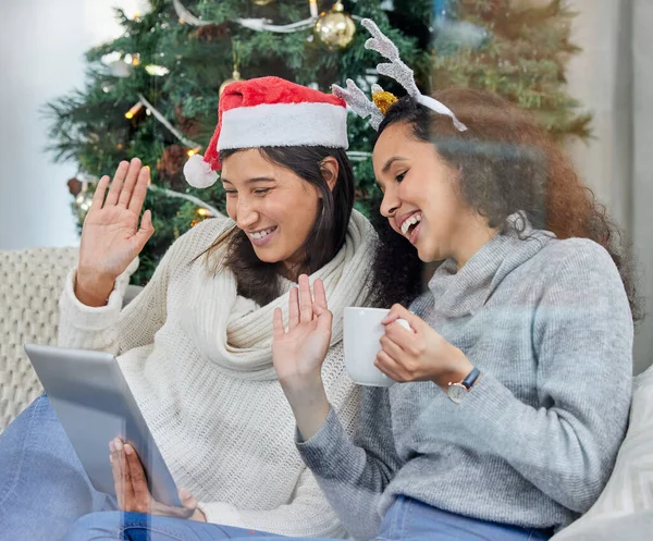 Its easy to keep in touch with loved ones. two young women on a video call using a digital tablet at home