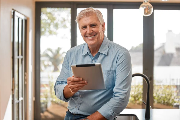 This thing comes in handy. a senior male realtor using a digital tablet