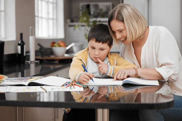 You can do this. a beautiful mother helping her son with his homework