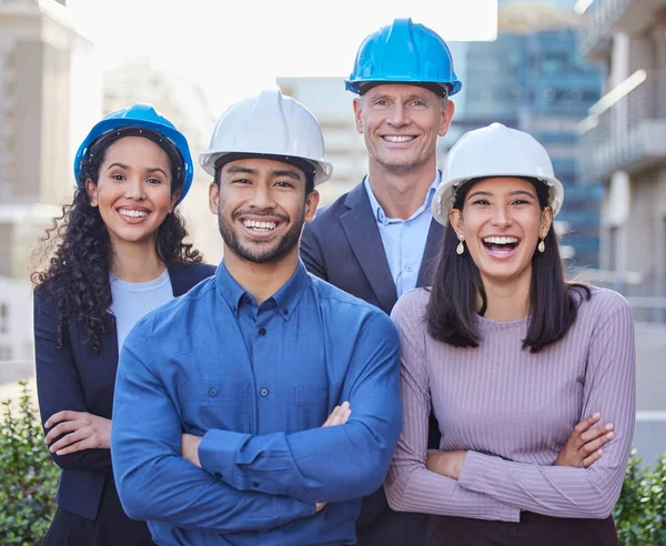 Were the best architects in the city. a diverse group of businesspeople standing together with their arms folded while wearing hardhats