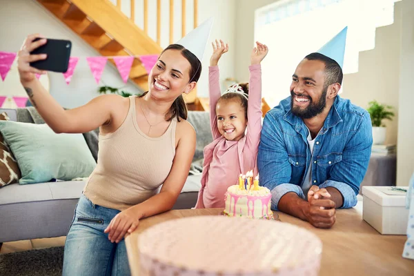 Well have these memories forever. a young mother taking a selfie at her daughters birthday celebration at home