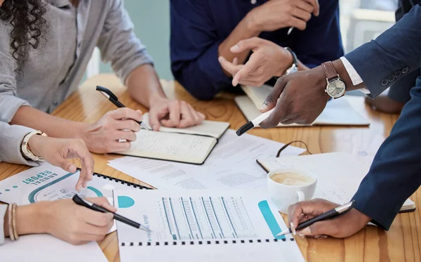 Coming together to get a closer look at whats happening. Closeup shot of a group of unrecognisable businesspeople going through paperwork together in an office