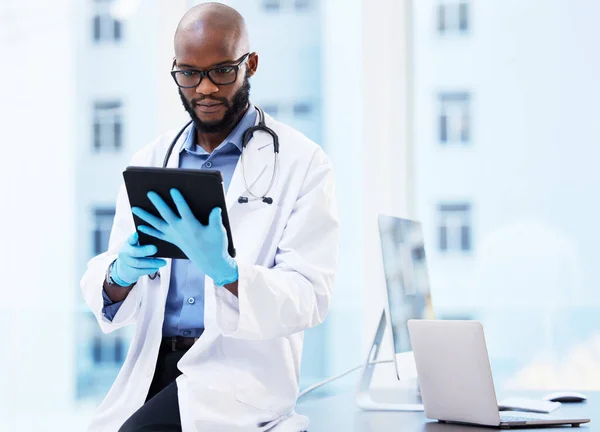 Hmm Need More Research Handsome Young Doctor Sitting Alone His — Fotografia de Stock