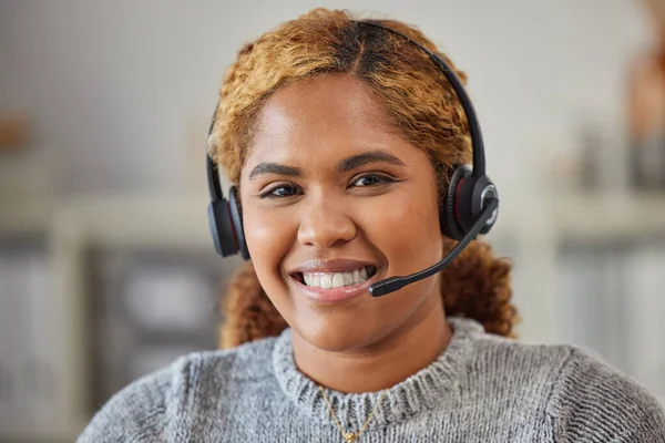 African female call center agent smiling and happy to help in her office at work. Portrait of a young woman customer service employee looking excited and ready to support clients in her workplace.