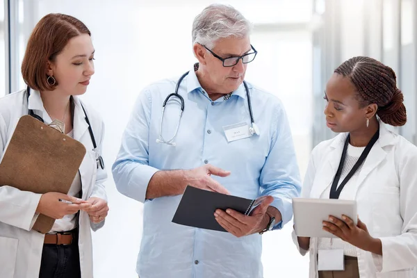 I think this new treatment might work. a team of doctors reading through medical information together