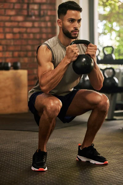 stock image Zero excuses, 100 work. a young man working out with a kettle bell in a gym