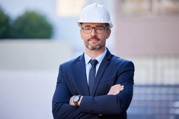 The perfect manager for any construction site. Cropped portrait of a handsome mature male engineer standing with his arms folded outside in the city