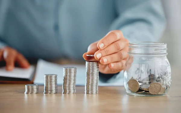 Hands holding coin pile to make a finance budget and successful financial choices. Closeup of money management and saving success. Stacked savings for the future, investment and retirement.