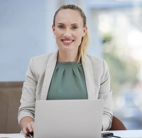 I love my job. a young businesswoman working at her desk using her laptop