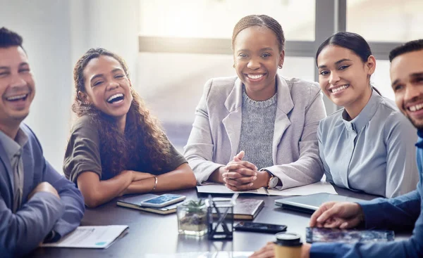 We make a great team. a group of colleagues having a meeting in a boardroom at work