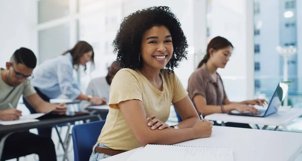 Sought for with ardor and attended to with diligence. Portrait of a happy young student among her classmates in a classroom at university