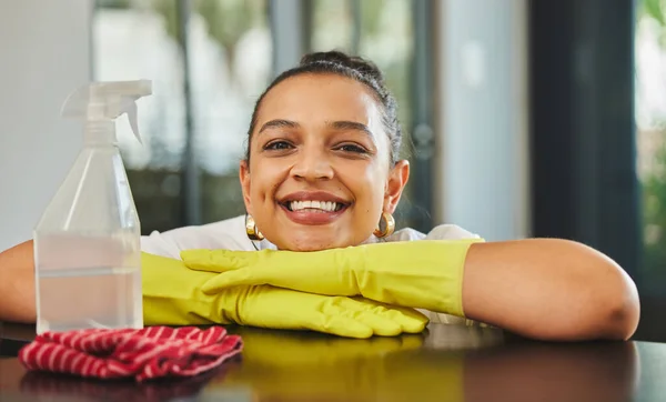 I love having a clean home. a young woman about to clean a wood table