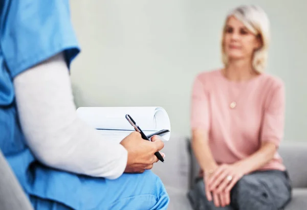 Lets Talk Your Health Female Nurse Sitting Clipboard While Having — Foto Stock