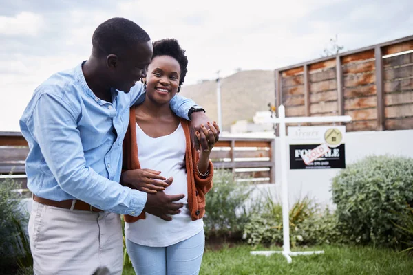 We found a house big enough for our growing family. a young couple standing outside their new home