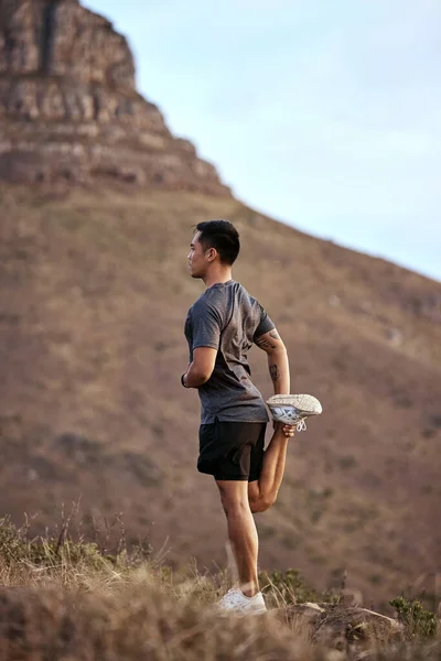 A good day starts with a good workout. a young man exercising in nature