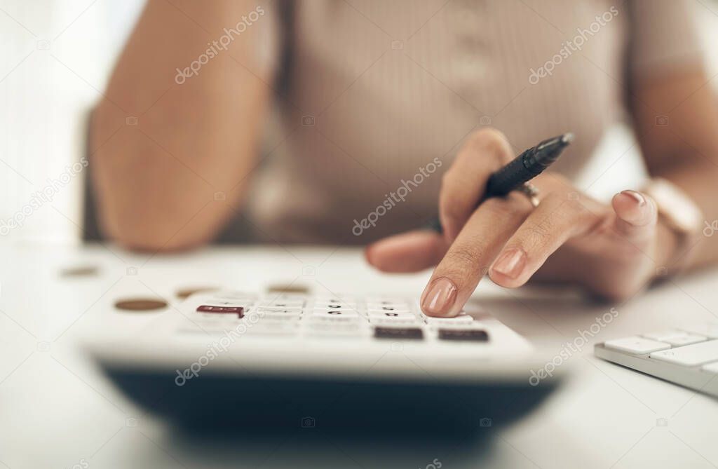 Having a budget keeps your spending and saving in check. Closeup shot of an unrecognisable businesswoman calculating finances in an office