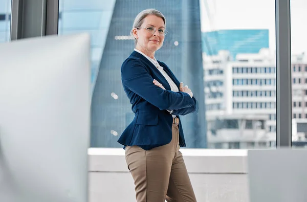 Im taking this business to the next level. a mature businesswoman standing alone in the office with her arms folded