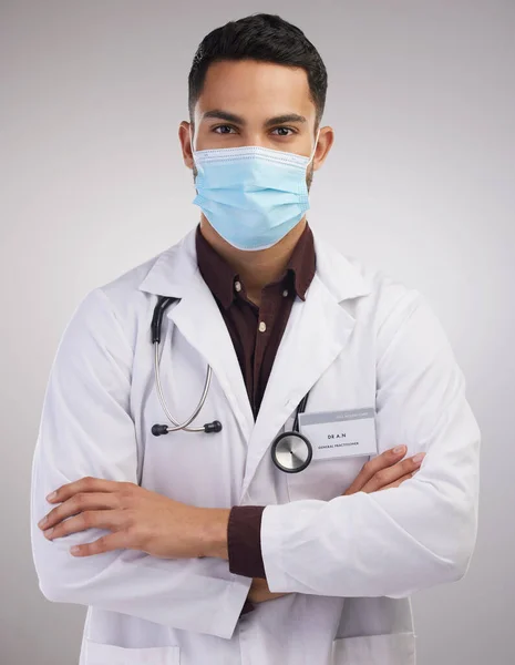 Safety First Handsome Young Doctor Standing Alone Studio His Arms — Stockfoto