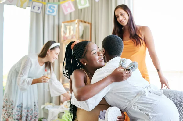 Im so thankful for you. a young mother to be hugging her friend for a gift given at her baby shower