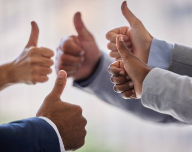 Success is what drives us. an unrecognizable group of businesspeople standing together in the office and making a thumbs up gesture