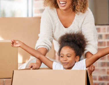 Every day I become a bit more like my mother. a mother pushing her daughter in a box at home