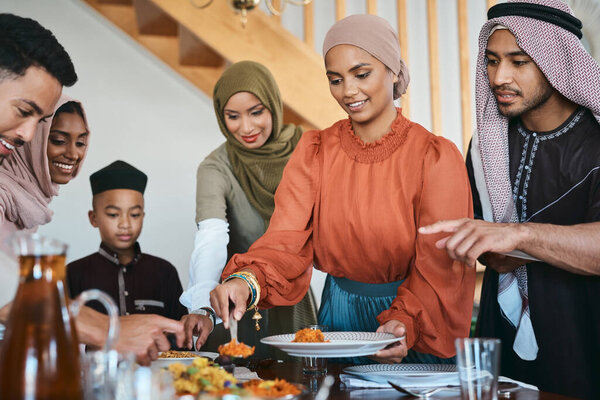 Fill up your plate. a muslim family dishing lunch for themselves