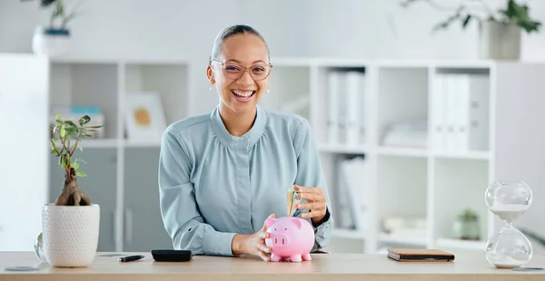 Finance, budget and investment money in piggybank and saving cash for a company startup in office. Portrait of smiling, happy and ambitious financial advisor planning future and depositing currency.