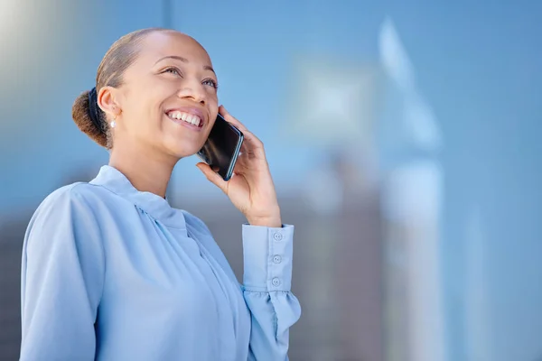 Businesswoman talking on a phone call, smiling joyful at the news received. Happy female manager on a cellphone chatting. Lady having pleasant phone conversation with client