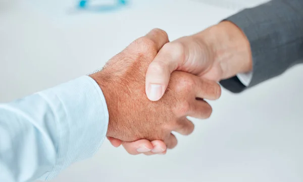 Reaching an agreement that suits them both. Closeup shot of two unrecognisable businesspeople shaking hands in an office