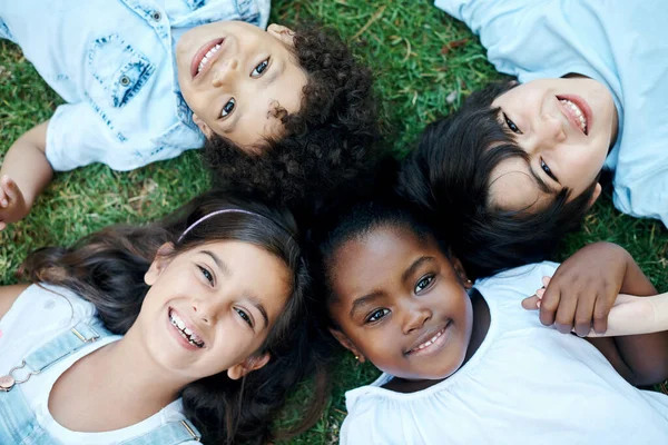 Meet Friends Four Adorable Kids Lying Together Lawn — стоковое фото