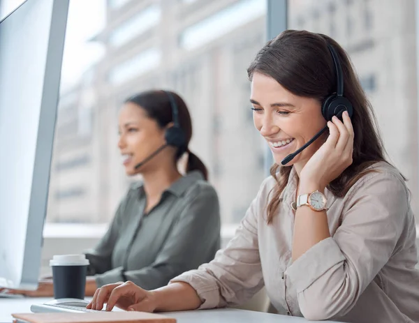 What can I do for you today. two young female call center workers in their office