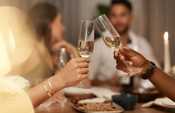 May we spend the year sipping expensive champagne. a diverse group of friends celebrating New Years together and toasting with glasses of champagne