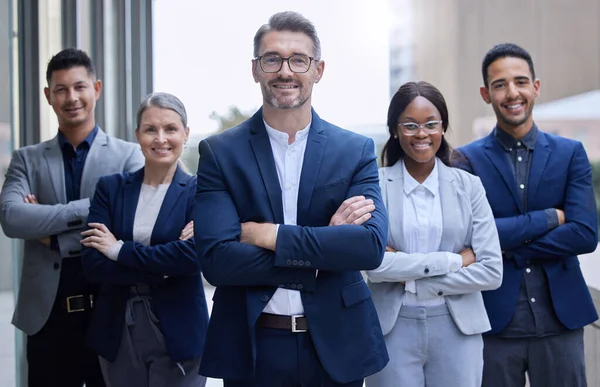 You cant go wrong with this team. Cropped portrait of a group of corporate businesspeople standing outside with their arms folded