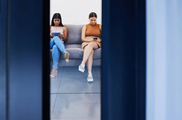 Focused Goal Ahead Two Young Women Using Devices While Waiting — 스톡 사진