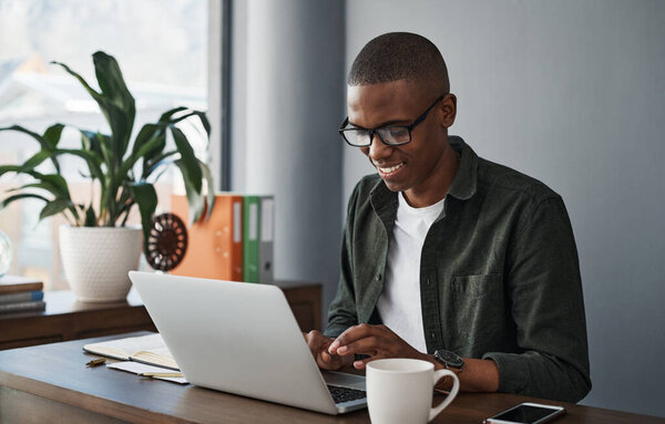 This email is important for my business. a young businessman typing on his laptop